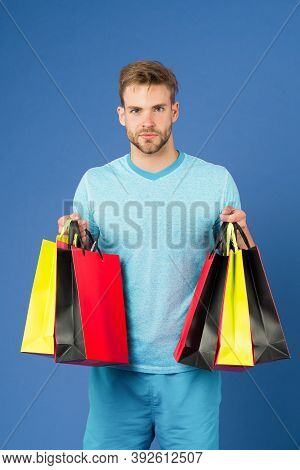 Capture Opportunity. Man Bearded Face Holds Shopping Bags. Guy Bought Lot Sporty Clothes And Accesso