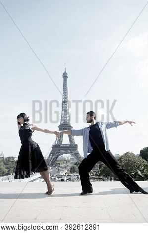 Dance Couple In Front Of Eifel Tower In Paris, France. Beatuiful Ballroom Dance Couple In Dance Pose