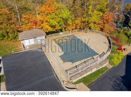 Aerial Drone Point Of View Of A Green Plastic Cover On Hoa Swimming Pool Protecting It From Leaves A