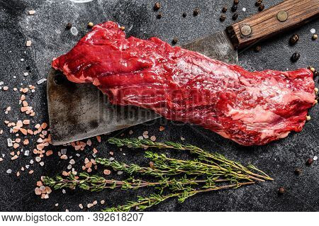Raw Skirt, Machete Steak On A Meat Cleaver. Black Background. Top View