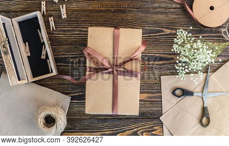 Craft Paper And Tools For Creating And Decorating Gift Packaging. There Is Cardboard, Brown Ribbons 