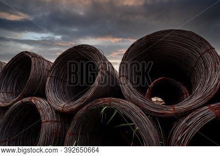 Steel Wire Coil Against Dark Sky. Metal Steel Reinforced For Concrete Construction. Iron Wire For Co