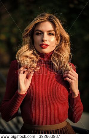 Girl Long Blond Hair. Girl Red Lipstick In Knitwear Sweater. Cosmetics And Skin Care Trend. Autumn W