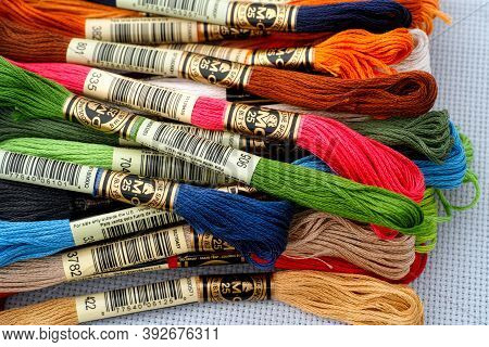 Tambov, Russian Federation - October 20, 2020 Heap Of Different Colors Dmc Six Strand Floss On White