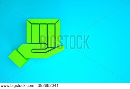 Green Delivery Hand With Cardboard Boxes Icon Isolated On Blue Background. Door To Door Delivery By 