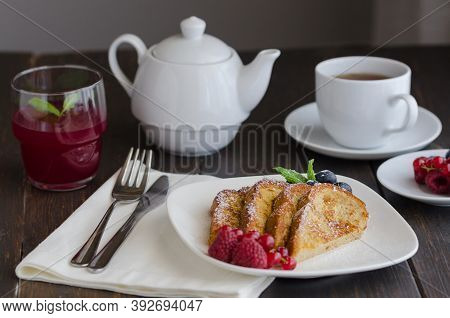 Spanish Torrijas Or French Toasts With Berries And Icing Sugar For Breakfast In Hotel Restaurant.