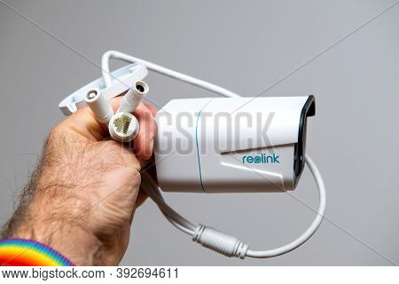 Paris, France - Oct 24, 2020: Pov Male Hand Holding Against White Background New Reolink Cctv Survei