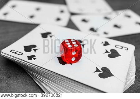 Red Dice Lie On A Deck Of Cards In A Casino. Casino Gambling With Dice And Cards