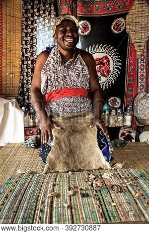 African Male Traditional Healer Known As A Sangoma Or Witch-doctor Performing A Spiritual Reading