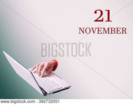 21th Of November. A Hand Is Typing On A Laptop The Announcement Of The Date Of A Business Meeting Or