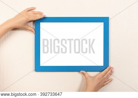 Mockup Diploma. Woman Hanging Photo Frame Mockup On Wall. Certificate, Diploma, Picture, Gratitude W