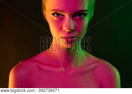 Mavelous. Portrait Of Female Fashion Model In Neon Light On Dark Studio Background. Beautiful Caucas