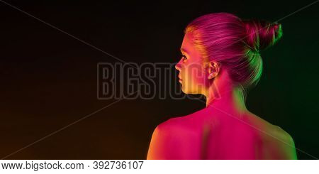 Mavelous. Portrait Of Fashion Model In Neon Light On Dark Studio Background. Beautiful Caucasian Wom