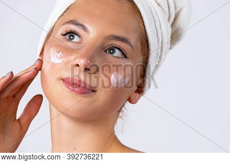 A Sweet Girl Applied The Cream To Her Cheeks, Making The Skin Softer And More Hydrated. Skin Care Co