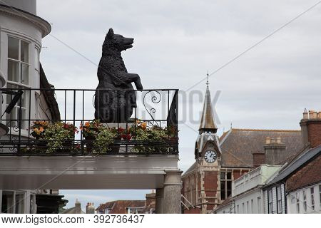 A Statue Of A Large Bear Looks Out Along South Street From A Hotel Balcony In Wareham, Dorset In The
