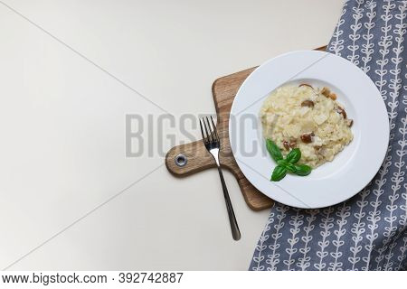 Vegetarian Gourmet Mushroom Risotto On A White Plate, Yellow Background, View From Above. Risotto Is