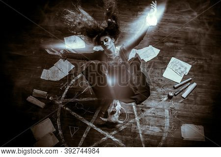 A portrait of a scary witch in the wooden house in green smoke. Magic, dark force, spell. 