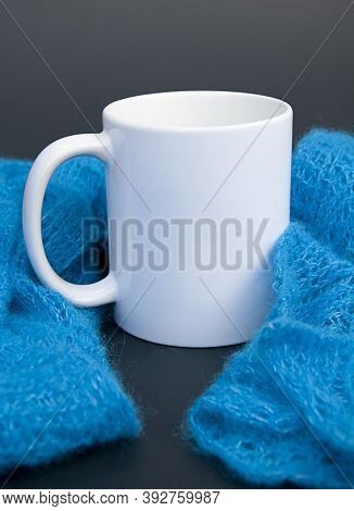 White Coffee Mug And Blue Scarf With Copyspace For Mockup Of This Soft Handknit Lace Scarf.