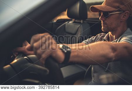 Caucasian Men Behind The Wheel. Driver In His 40s On The Road Trip In His Cabrio Vehicle. Transporta