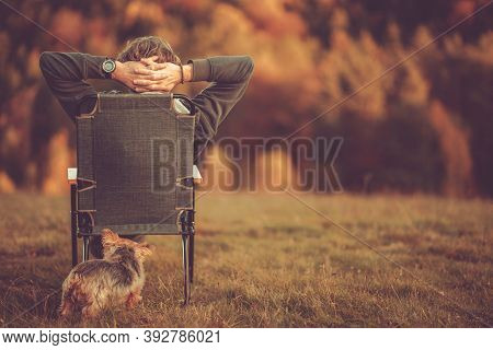 Retired Caucasian Men In His 50s Enjoying His Stress Free Life In The Nature. Seating Somewhere Outd