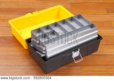 Plastic Box To Organize Tools; Photo On Wooden Background.