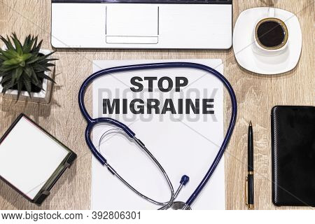 Text Stop Migraine In A Notebook On Medical Forms With A Phonendoscope Cup Of Coffee, Pen, Laptop . 