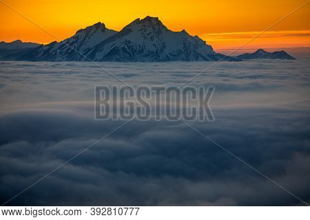 Splendid apline scenery. High mountains with fog and lovely evening light.