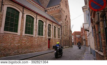Bruges, Belgium - May 12, 2018:  Roofs And Windows Of Old Authentic Brick Houses On Street Sint-jako