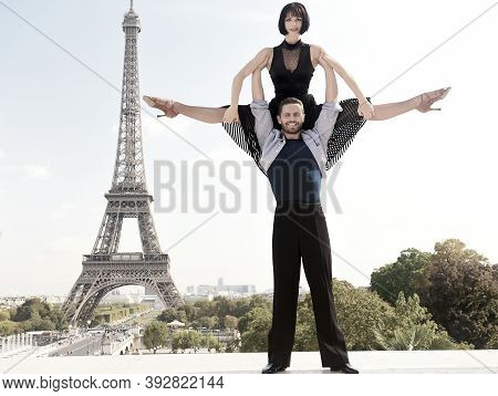 Dance Couple In Front Of Eifel Tower In Paris, France. Beatuiful Ballroom Dance Couple In Dance Pose