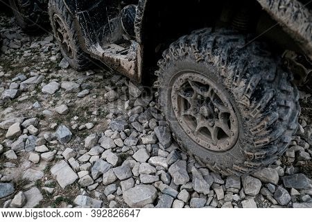 Closeup View Of Dirty Muddy Quad Bike Tire. Off-road Extreme Transportation For Adventurous Lifestyl