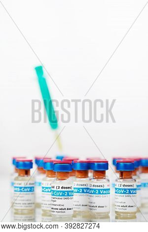Bottles Of New Sars-cov-2 Vaccine On Table With Plastic Syringe