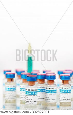Bottles Of New Sars-cov-2 Vaccine On Table With Plastic Syringe