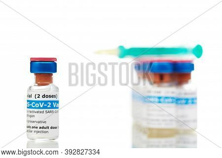 Bottles Of New Sars-cov-2 Vaccine On Table With Plastic Syringe