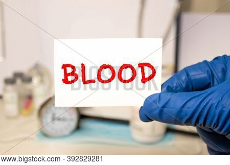 The Doctor Holds A Card With The Text Blood. Medical Concept