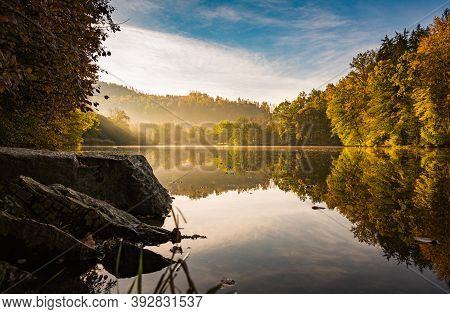 Lake Fog Landscape With Autumn Foliage And Tree Reflections In Styria, Thal, Austria. Autumn Season 
