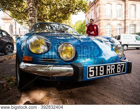 Strasbourg, France - Oct 1, 2017: Man Looking At The French Street With Vintage Blue Alpine A110 Ber