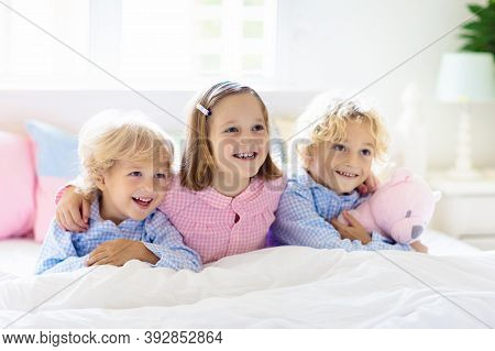 Kids Play In Bed. Children At Home.