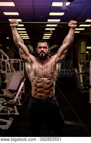 Strong Athlete Man Holding Crossbar In Night Gym