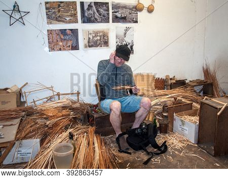Camacha, Madeira, Portugal - April 19, 2018: A Tourist Is Trying To Make A Wicker Basket In A Factor
