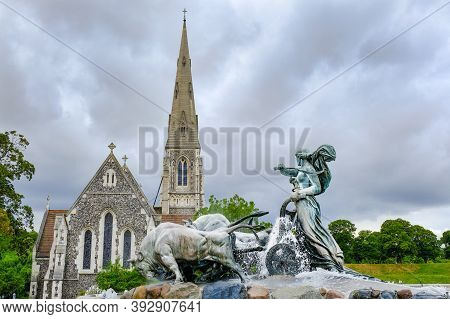 Gefion Fountain And St. Albans Church Under A Stormy Dramatic Cloud Sky: Copenhagen, Denmark - July 