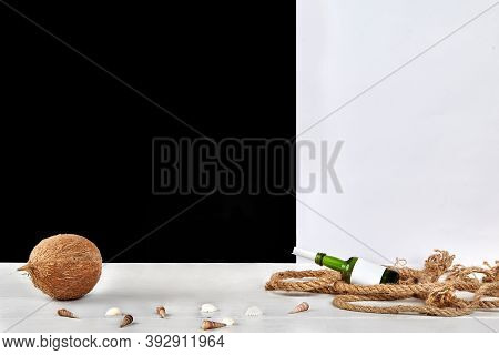 Ripe Coconut, Seashells, Glass Bottle With Copy Space And Rolled Sheet Of Paper In It, Thick Rope On