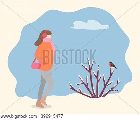 Woman Wearing Warm Winter Jacket And Carrying Handbag Walking In Forest Or Park. Female Passing Bush