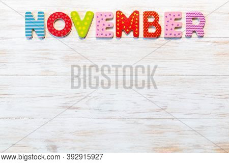Wooden Letters Written November Month On Vintage Background. Inscription November With Copy Space. T
