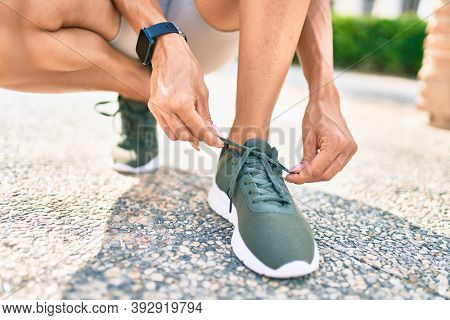 Close up of woman feet wearing training sneakers doing lace ready for running