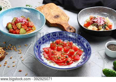Stracciatella Salad With Tomatoes And Watermalone And Ingredients On Light Concrete Table