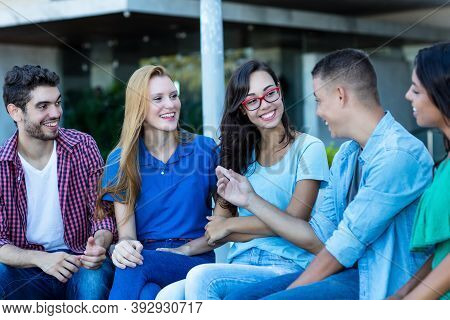 Group Of International Young Adults Talking About Politics Outdoor In City