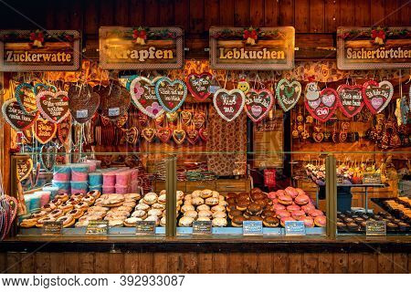 VIENNA, AUSTRIA - DECEMBER 03, 2019: Wooden kiosk with traditional homemade sweets and cookies on annual Christmas market held in different parts of the Vienna, Austria.