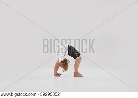 Full Length Shot Of Little Playful Boy Child Standing In Bridge Pose, Bending Over Backwards Isolate