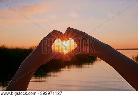 Child Is Forming A Heart Around The Sun, In Front Of The Lake Chiemsee During Sunset