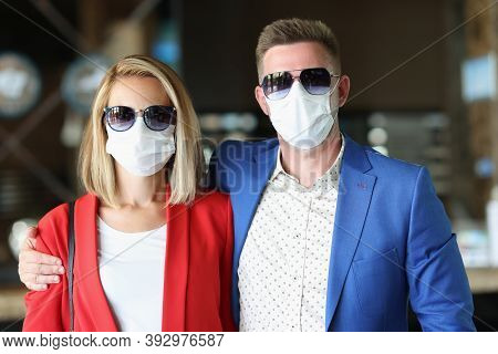 Portrait Of Man And A Woman In Sunglasses And Protective Medical Masks. Health Safety In Travel And 